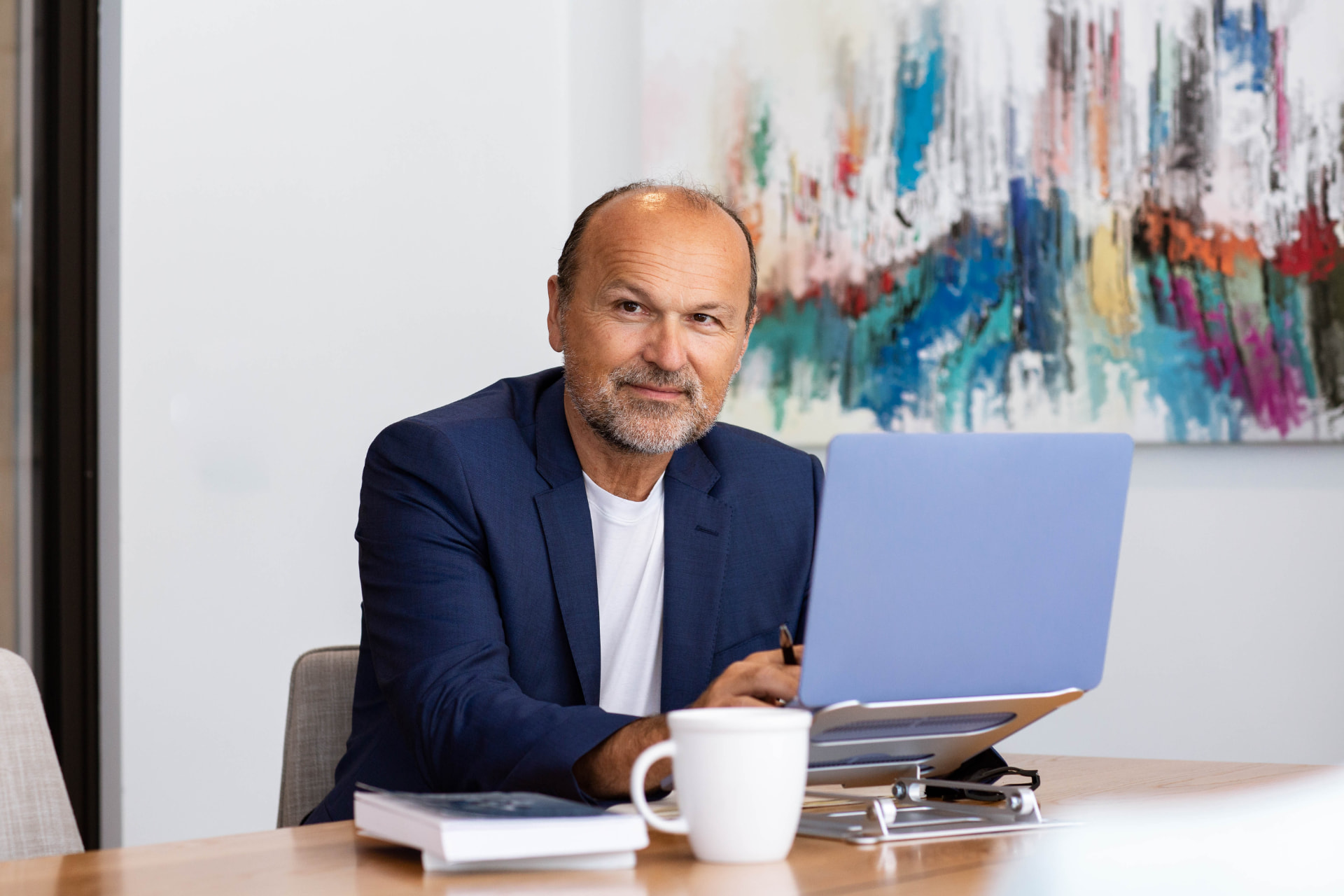 Sascha Menesi reviewing candidate profiles on his laptop
